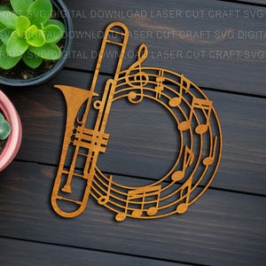 May include: A wooden laser-cut design featuring a trombone and musical notes. The trombone is positioned on the left, with a circular arrangement of notes and a treble clef on the right. The design is a warm brown color.