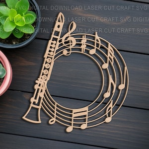 May include: A laser-cut wooden clarinet with musical notes and a treble clef. The design is a light brown color and is set against a dark wood background. The image also includes potted succulents.
