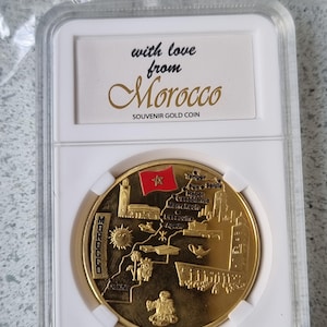 A gilded commemorative coin of Moroccan origin, a rare and beautiful piece with exquisite decorations that symbolize Moroccan culture, and t