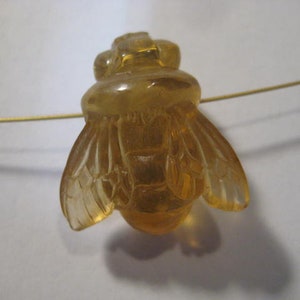 carved Amber  Bee bead  . Real . Natural Amber .        21 x 18 x 11 mm .        B5339