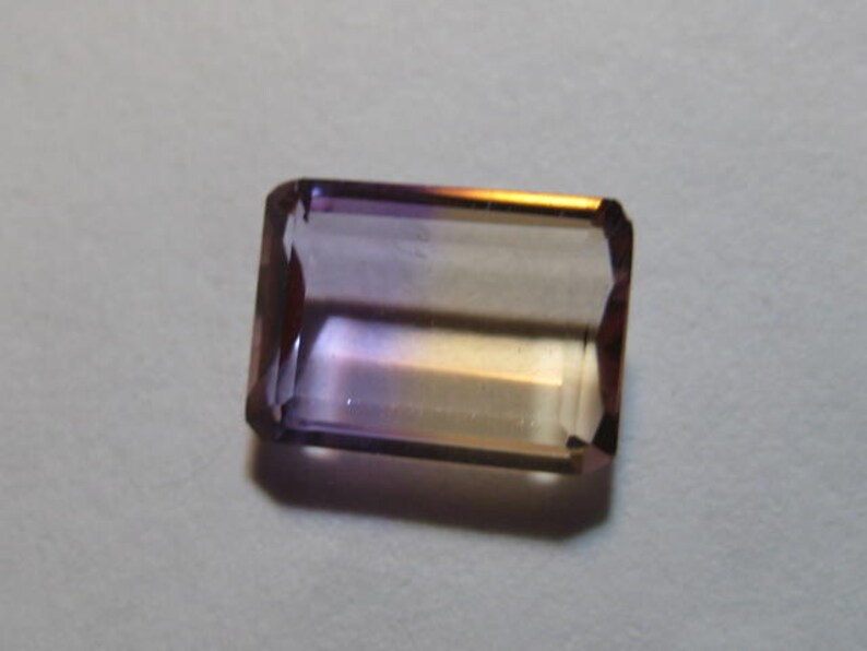 Ametrine faceted gemstone ....................... B698 9.5 x 7 x 3.2 mm .....