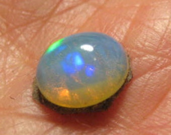 Ethiopian Opal cab    9 x 8 x 4 mm .           B5473