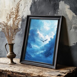 May include: A framed print depicting a dragon flying through a dramatic, blue sky filled with clouds. The artwork is in a black frame, set against a textured wall. A decorative vase with dried plants is on the left.