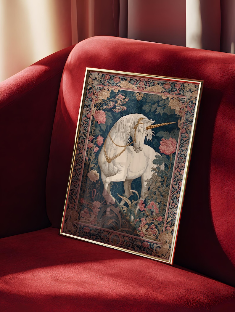 May include: A framed print featuring a white unicorn with a golden horn and bridle, set against a backdrop of floral and foliage patterns. The artwork is in a gold frame and rests on a red velvet surface.