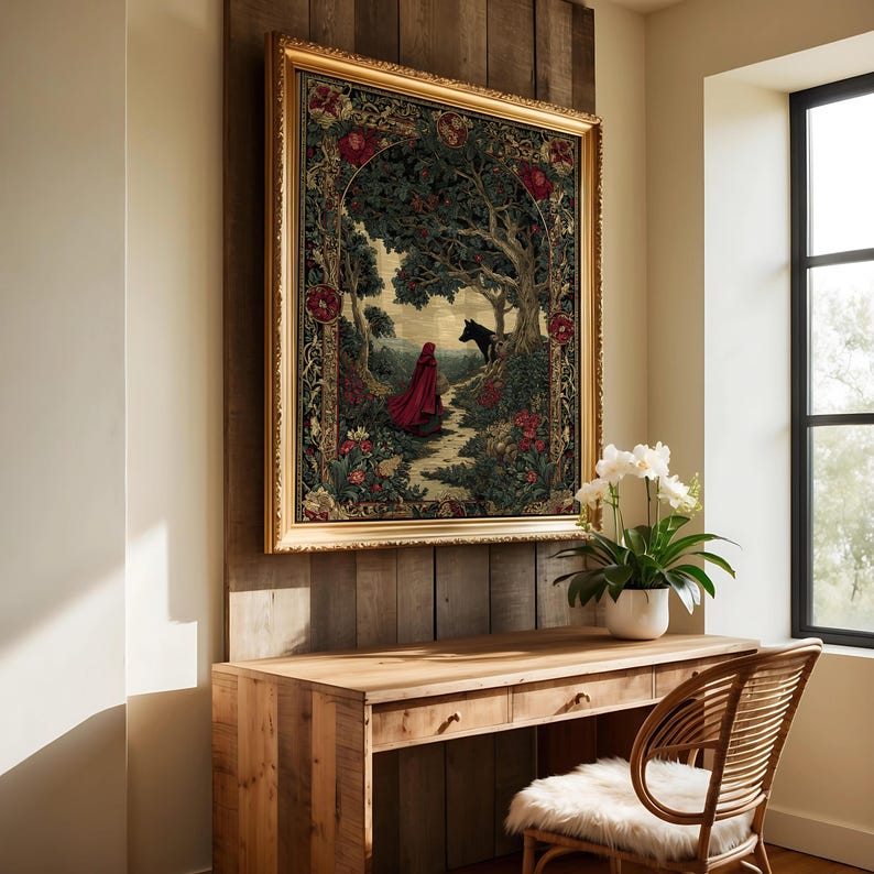 May include: A framed tapestry depicting a forest scene with a figure in a red cloak walking a path. The artwork features a gold frame and is mounted on a wooden wall. The scene includes a black wolf and lush foliage.