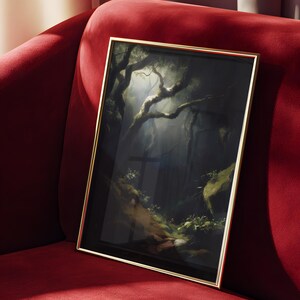 May include: Framed artwork featuring a dark forest scene with sunlight filtering through the trees. The painting has a gold frame and is displayed on a red velvet couch. The artwork depicts a moody, atmospheric landscape.