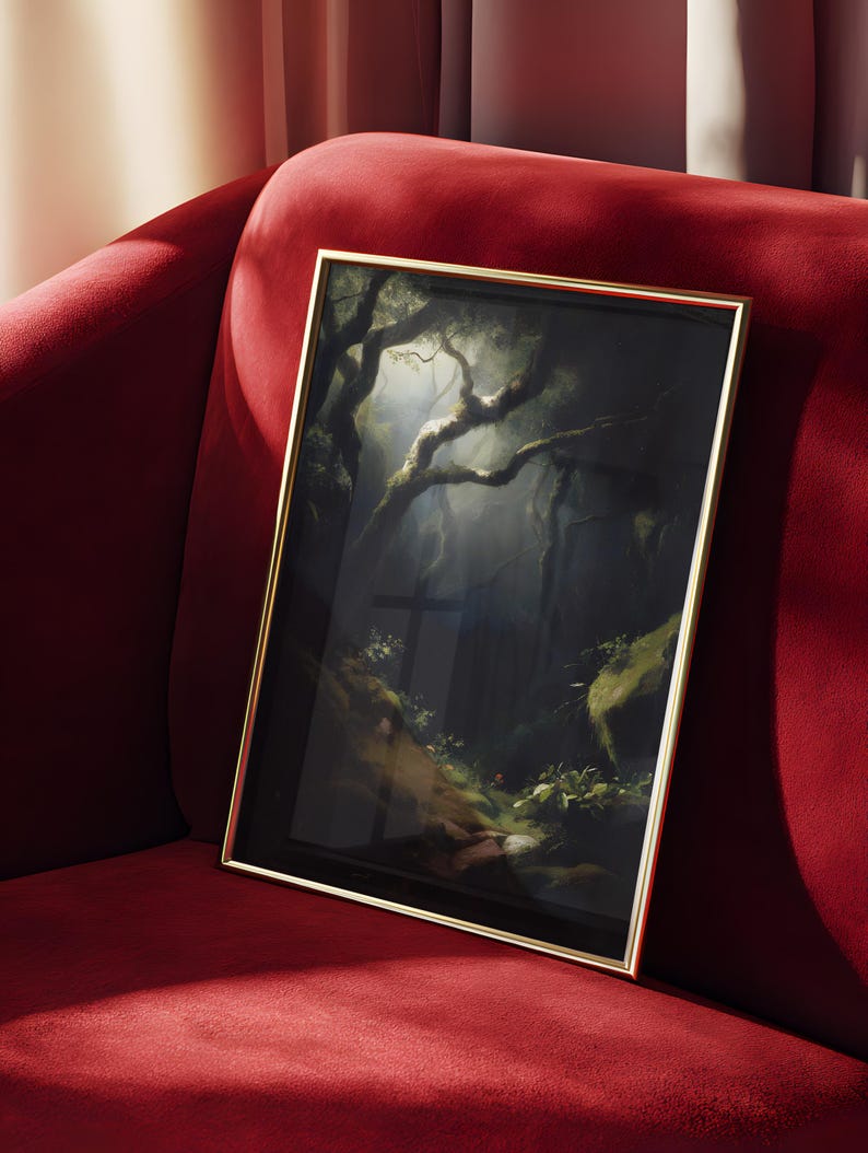 May include: Framed artwork featuring a dark forest scene with sunlight filtering through the trees. The painting has a gold frame and is displayed on a red velvet couch. The artwork depicts a moody, atmospheric landscape.