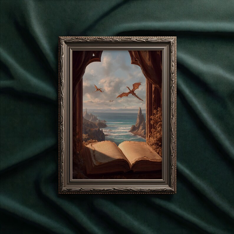 May include: Framed artwork depicting a fantasy scene with dragons soaring over a coastal landscape. The artwork is framed in a silver-colored ornate frame. An open book is in the foreground, with the ocean and sky visible through a window.