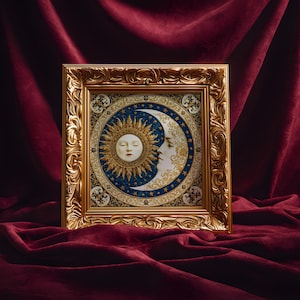 May include: A square wall art piece in an ornate gold frame featuring a circular illustration of a sun and moon face. The artwork displays a golden sun with rays and a white crescent moon against a deep blue background filled with gold stars.