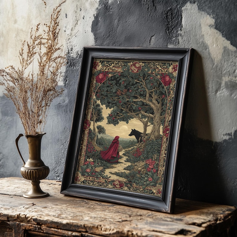 May include: Framed art print featuring a scene from a fairy tale. The artwork depicts a figure in a red cloak walking on a path towards a wolf under a tree. The frame is black, and the artwork has a vintage aesthetic with floral and tree details.