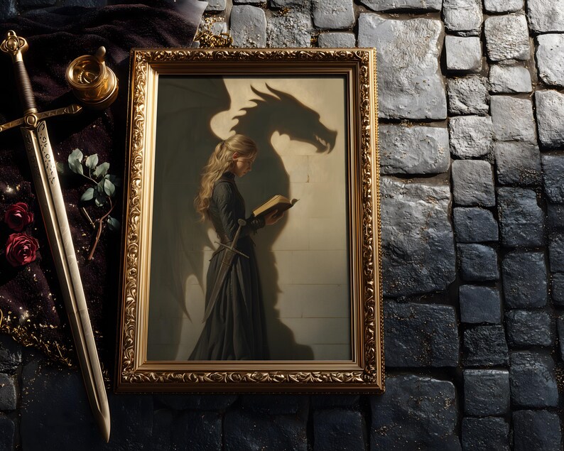 May include: A framed artwork with a gold ornate frame depicts a woman in a black dress reading a book, with a dragon shadow behind her. A sword, roses, and a decorative item are next to the frame. The artwork has a fantasy theme.
