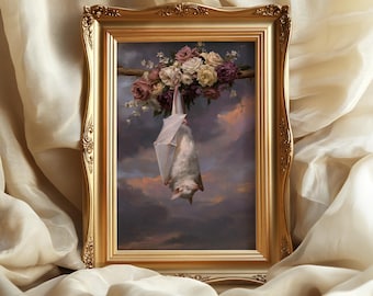 May include: A framed wall art print featuring a white bat hanging upside down from a branch adorned with a cluster of pink, white, and deep red roses against a cloudy, sunset-toned sky, encased in an ornate, metallic gold-colored frame.