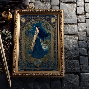 May include: A framed artwork with a gold ornate frame. The artwork depicts a woman in a blue dress standing near a stream in a forest. A sword, a decorative container, and roses are next to the frame. The background is a dark stone surface.