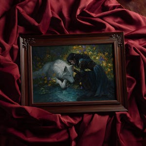 May include: A framed artwork featuring a woman and a white wolf in a forest setting. The woman, in a dark blue dress, is interacting with the wolf near a body of water. The frame is dark brown, and the background is a deep red fabric.
