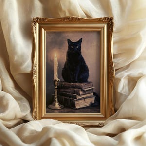 May include: A framed print featuring a black cat sitting atop a stack of weathered, antique books next to a tall, lit candle in a metallic candlestick. The artwork is encased in an ornate, rectangular gold frame with intricate detailing.