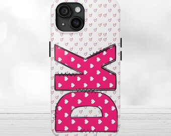May include: A white phone case with a pink "OK" design. The letters are filled with white hearts and outlined in black. The background has a pattern of small pink and purple hearts.