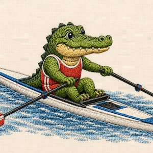May include: An embroidered design featuring a green crocodile wearing a red tank top with white trim, sitting in a white and blue rowing shell. The crocodile holds two oars with red and white striped blades, positioned over blue stitched water.