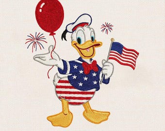 May include: An embroidered design of a white duck wearing a blue jacket with white stars, a red bow tie, and a sailor hat. The duck holds a red balloon and a small American flag, with red and blue firework bursts surrounding the figure.