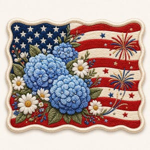 Op de afbeelding: Geborduurde patch met de Amerikaanse vlag, versierd met blauwe hortensia's en witte madeliefjes. Het vlagontwerp omvat sterren, rood-witte strepen en vuurwerk. De patch heeft een golvende, crèmekleurige rand.