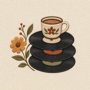 May include: An embroidery design featuring a stack of three black vinyl records topped with a cream-colored ceramic cup filled with brown liquid. The cup has a small brown flower motif. Beside the records is a stem with a yellow flower and buds.