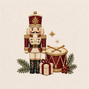May include: An embroidered nutcracker figure in a red and cream uniform with gold accents, standing beside a red drum with gold trim, a small cream gift box with a red ribbon, green pine sprigs, red berries, and two small gold star icons.