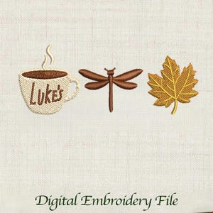 May include: An embroidered design featuring a coffee cup with the text "Luke's", a dragonfly, and a maple leaf. The design is in shades of brown and gold, with the text "Digital Embroidery File" at the bottom.