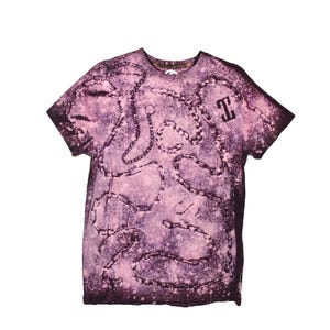 May include: A short-sleeved, purple t-shirt with a chain design and the letter "T" on the right chest. The shirt has a faded, distressed look with a light pink and dark purple color scheme.