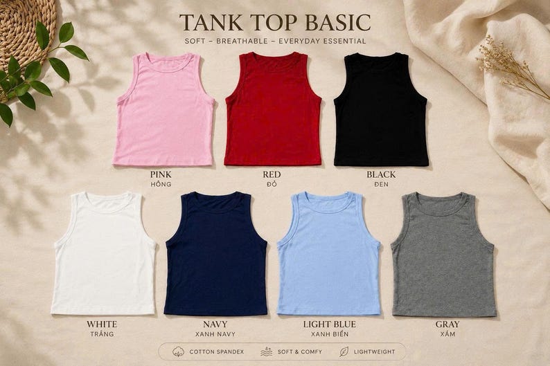 Op de afbeelding: Zeven mouwloze tanktops gerangschikt in twee rijen, met de tekst TANK TOP BASIC. De kleuren zijn roze, rood, zwart, wit, marineblauw, lichtblauw en grijs. Elke top heeft een ronde halslijn en een rechte zoom, gelabeld met kleurnamen in het Engels en Vietnamees.