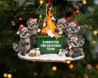 May include: A Christmas ornament featuring a group of raccoons wearing Santa hats around a dumpster fire. The ornament reads "DUMPSTER FIRE RESPONSE TEAM" and includes the text "NAME CAN BE CHANGED".