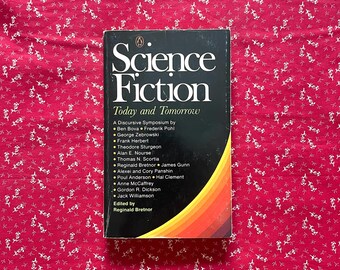 May include: A vintage paperback book titled "Science Fiction Today and Tomorrow" with a black cover and colourful stripes. The book features a list of authors and is set against a red floral patterned background.