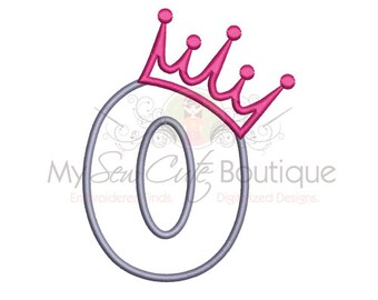 May include: A gray number zero with a pink crown on top. The crown has five points and is outlined in a darker pink.