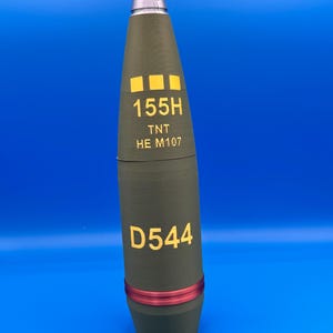 May include: A white ceramic mug with a black handle and the text "But First, Coffee" in a handwritten style. The mug is on a white surface. The mug is approximately 4 inches tall.