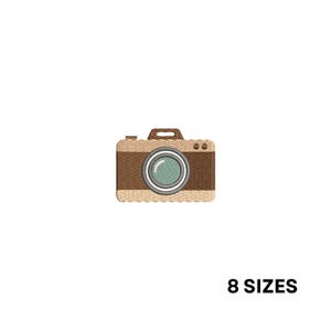 May include: Embroidered patch of a vintage camera in shades of brown and tan. The camera lens is light blue with a silver border. The text "8 SIZES" is below the camera.