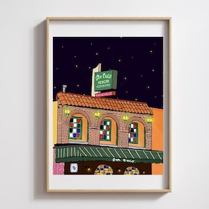 May include: A framed art print of a Mexican restaurant at night. The illustration features a brick building with a red tile roof, green awnings, and a sign that reads "Don Cuco Mexican Restaurants Cocktails" under a starry sky.