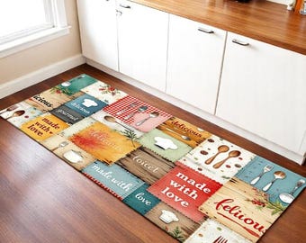 May include: A rectangular kitchen floor mat featuring a patchwork design of various textures and colors. The mat displays illustrations of chef hats, spoons, forks, and text including "delicious," "made with love," and "gourmet" in various fonts.