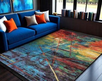 May include: Abstract area rug with a colorful design featuring shades of blue, red, yellow, and green. The rug has a black border and is laid out on a hardwood floor in a living room setting.