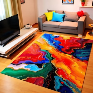 Könnte beinhalten: Ein lebendiger Teppich mit abstraktem Design. Der Teppich zeigt ein fließendes Muster aus roten, orangen, gelben, blauen und grünen Farbtönen mit goldenen Akzenten. Der rechteckige Teppich liegt auf einem Holzboden und verleiht dem Raum Farbe.