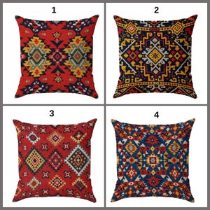 May include: Four square cushions with geometric patterns. The cushions feature designs in red, navy blue, yellow, and white. The patterns include diamond, zigzag, and tribal-inspired motifs. The cushions are arranged in a 2x2 grid.