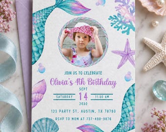May include: A rectangular birthday invitation card featuring watercolour illustrations of mermaid tails, seashells, coral, and bubbles. A circular photo frame displays a child wearing a pink hat. Text includes Olivia's 4th Birthday, Sept 14, 2030, 11:30 AM, 123 Party St, Austin, TX 78790, and RSVP to Mom at 737-498-9876.