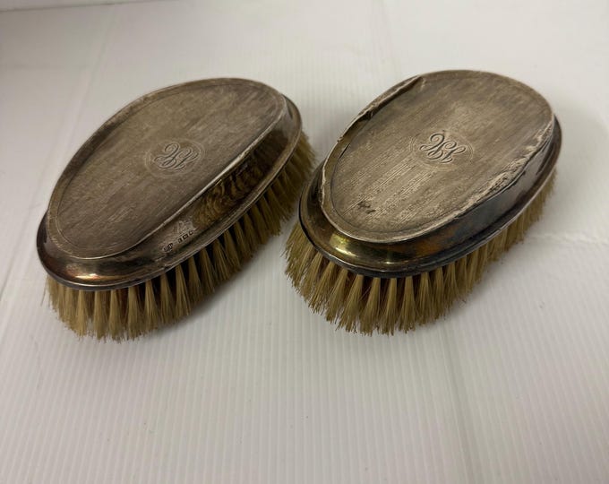 Antique English silver toilet brushes.