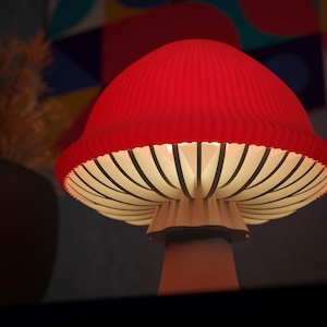 May include: A red mushroom-shaped lamp with a ribbed cap and a white underside with black lines. The lamp has a beige stem and is lit from within, creating a warm glow. The lamp is a decorative lighting fixture.