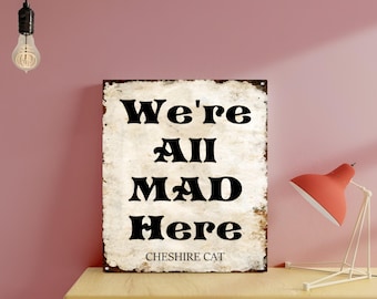 Estamos todos locos aquí colgando un cartel de metal con el gato de Cheshire para decoración del hogar.