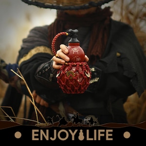 May include: A red gourd-shaped container with a black top and a braided handle. The container is adorned with a red net and coins. The text "ENJOY & LIFE" is displayed at the bottom of the image.