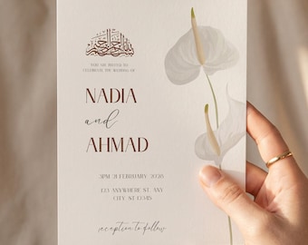 May include: A wedding invitation with a cream background, featuring the names "NADIA and AHMAD" in a dark brown font. The invitation includes the date, time, and location details. Decorative white flowers and calligraphy are also present.