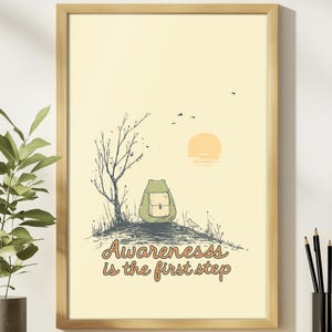 May include: Framed art print featuring a whimsical illustration of a frog with a backpack, perched on a hill with a tree and a setting sun. The text "Awareness is the first step" is written in a decorative font. The artwork is in a wooden frame.