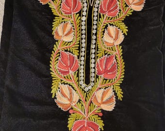 May include: A black velvet tunic with intricate floral embroidery in shades of red, green, and cream. The embroidery features delicate leaves and flowers.