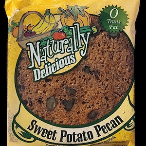 May include: A yellow bag with a picture of a sweet potato pecan loaf. The bag says "Naturally Delicious" and "0 Trans Fat". The net weight is 4 oz (113g).