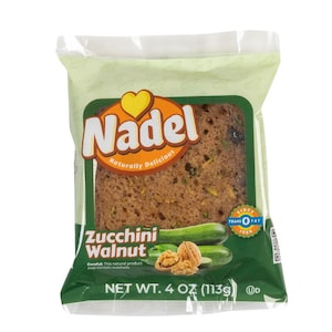 May include: A package of zucchini walnut bread from Nadel, a brand that emphasizes natural ingredients. The package is green and features a heart logo. The bread is visible through the clear plastic packaging. The package states "Naturally Delicious" and "Since 1989 Trans Fat Free". The net weight is 4 oz (113g).