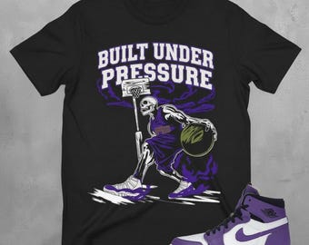 AJ 1 Crater Purple Sneaker Match T-Shirt Black Basketball Graphic “Built Under Pressure”