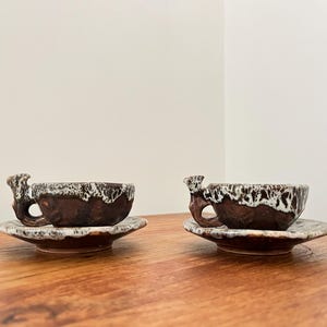 Pair of vintage handmade espresso cups with saucers
